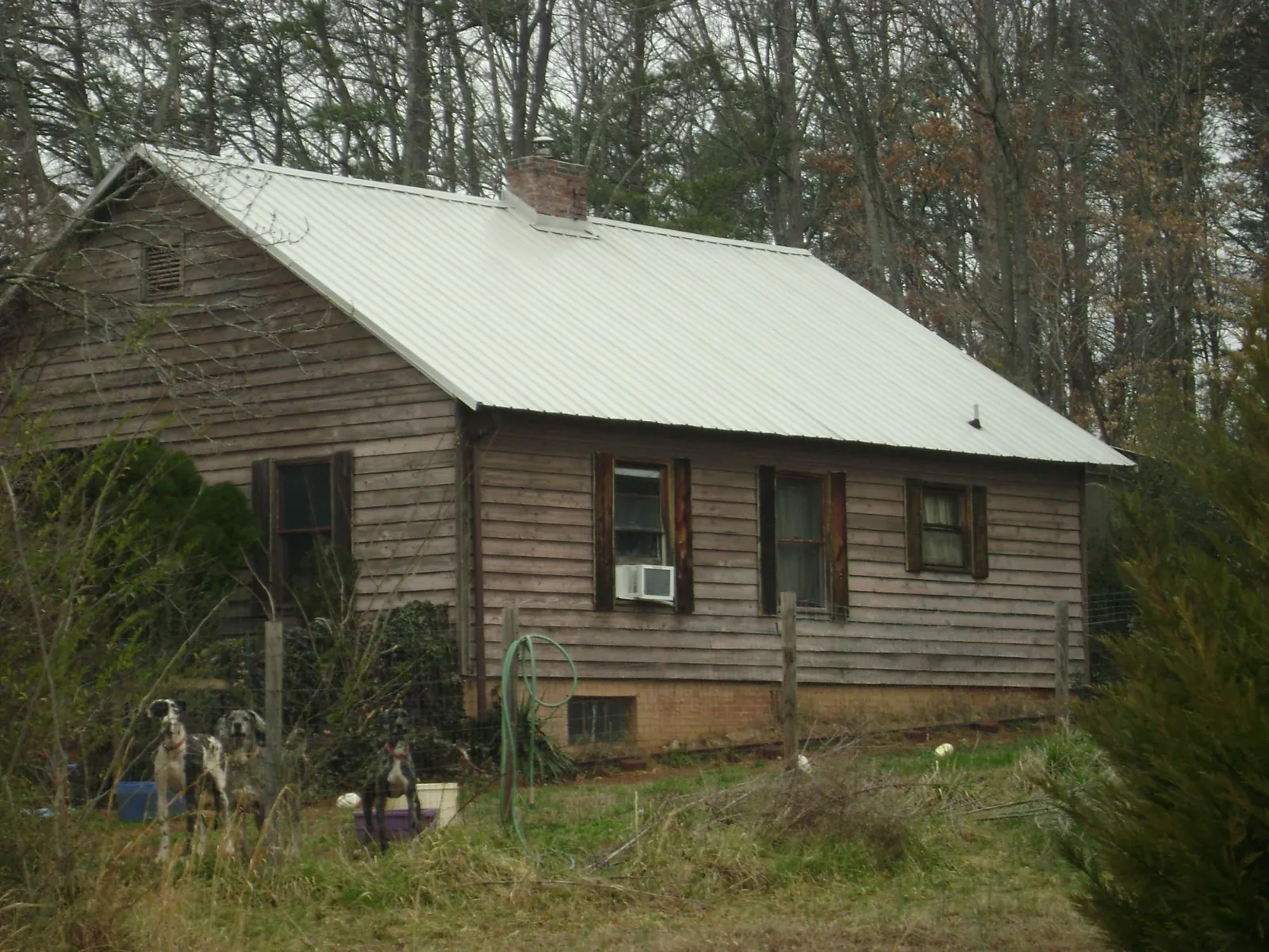 White metal roof on an old wood sided farmhouse, from a Metal Roof Installation job in Luthersburg
